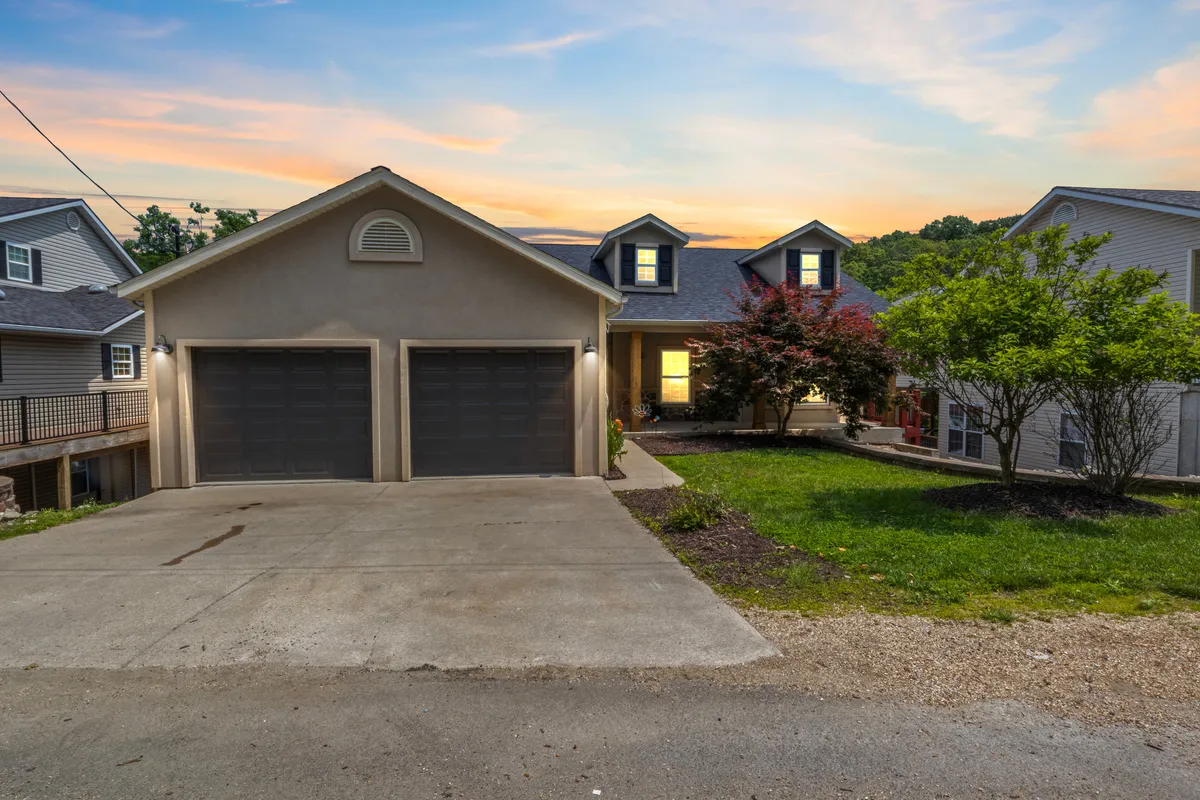 A welcoming view of the home’s facade, showcasing the landscaped front yard and two-car garage. The inviting exterior suggests plenty of space for guests to arrive, gather, and enjoy the outdoors, enhancing the sense of arrival for group events.